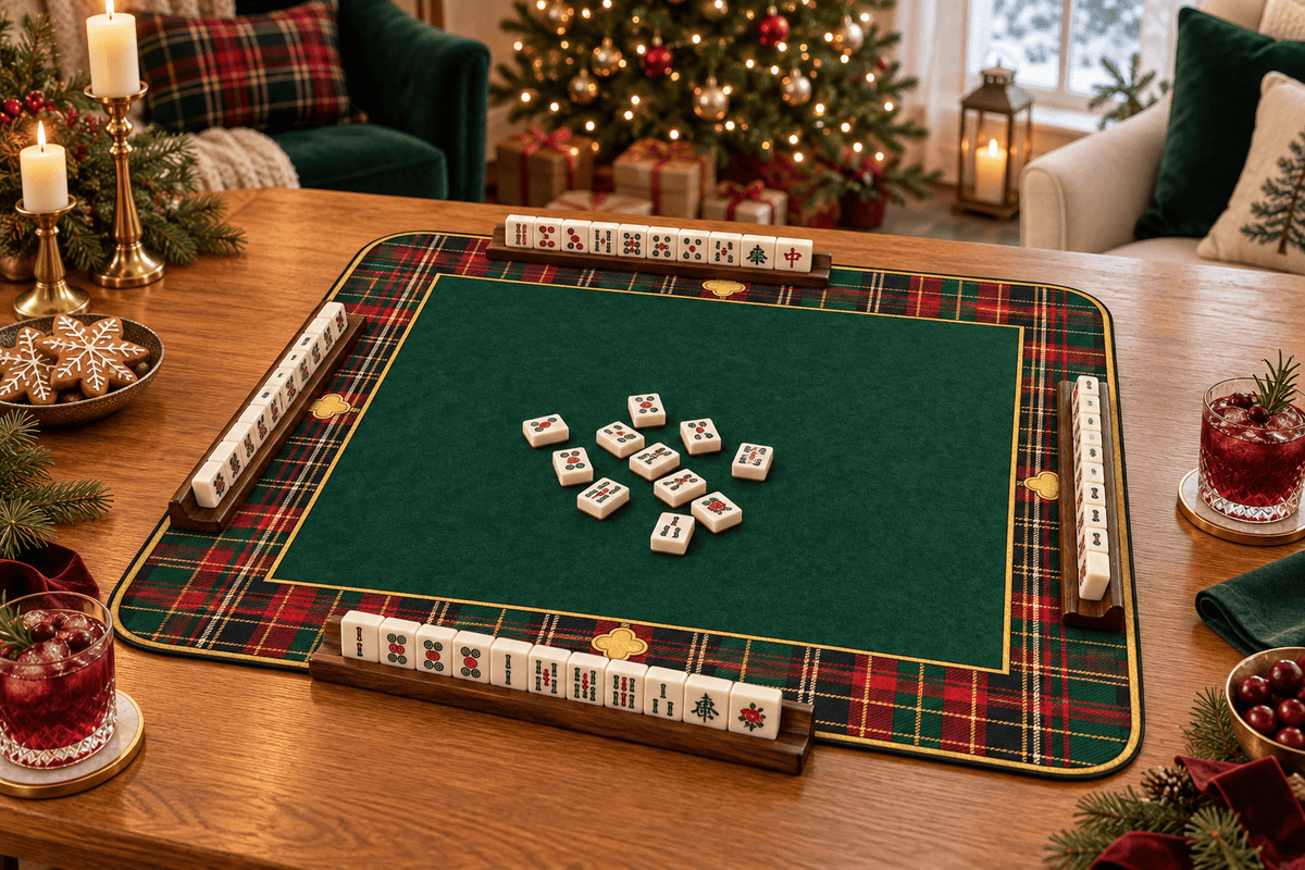 TARTAN & TIDINGS mahjong mat on a festive table with ivory tiles, cranberry drinks, cookies and Christmas lights.