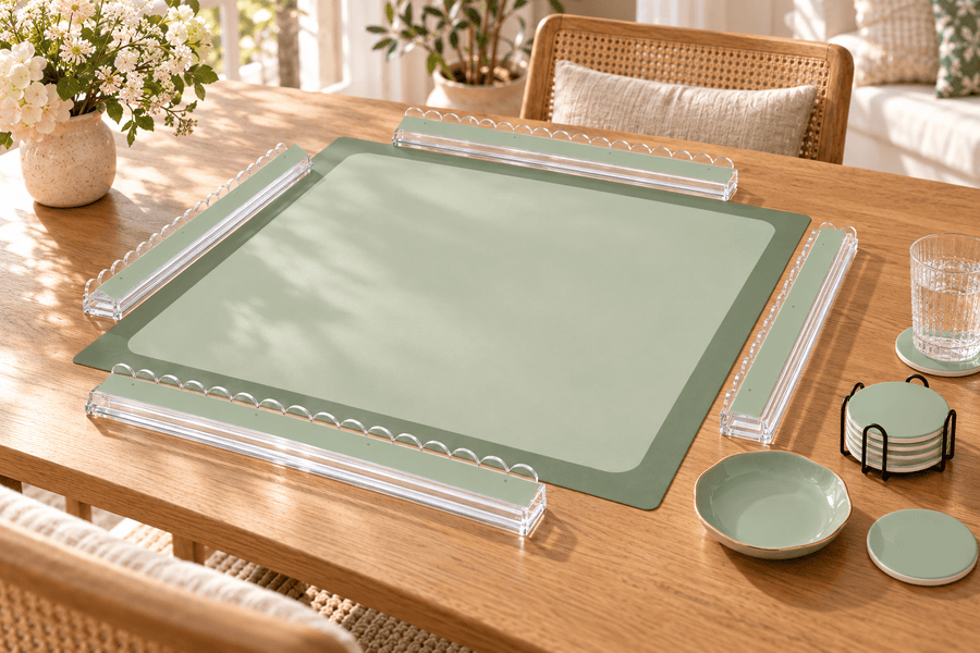 SOFT SAGE mahjong mat with sage green acrylic racks, a ceramic dice tray and ceramic coasters displayed on a sunlit oak table.