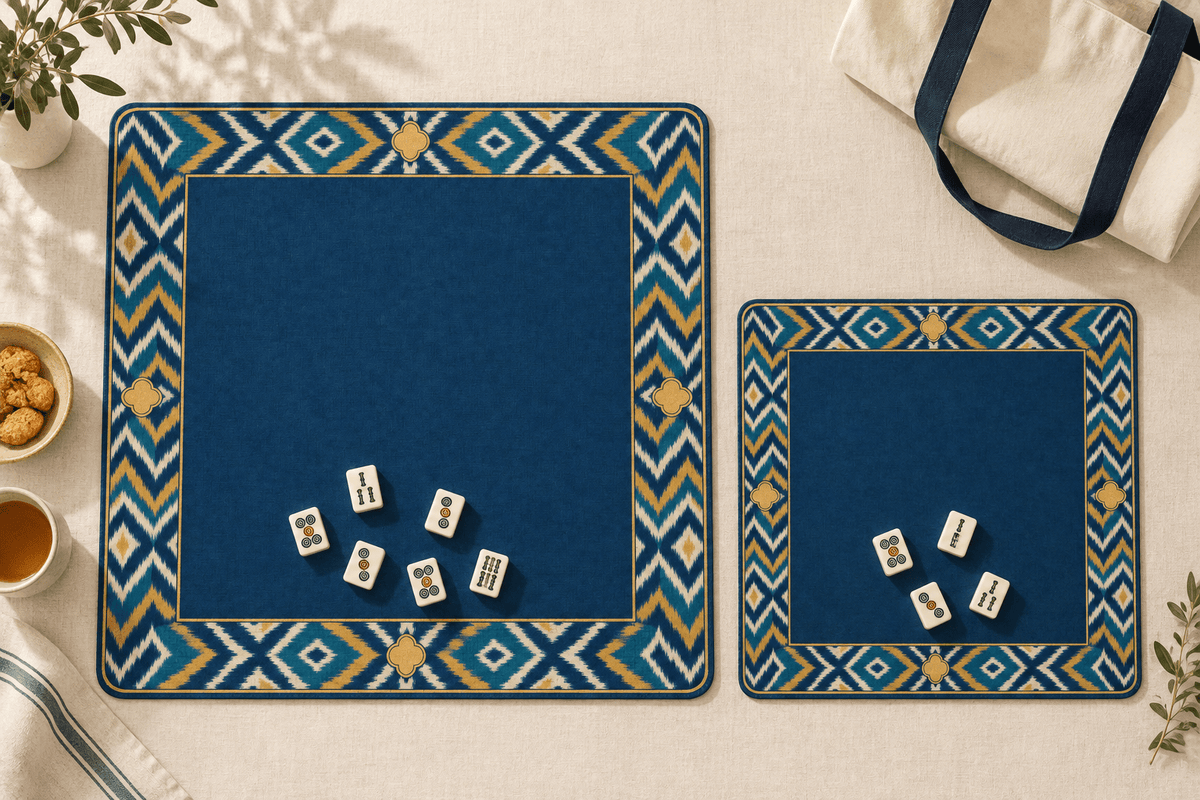 Standard and smaller travel INDIGO BATIK mahjong mats side by side with ivory tiles on cream linen.